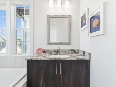 a bathroom with a sink and a mirror at CaSEAta by 30A Escapes in Rosemary Beach