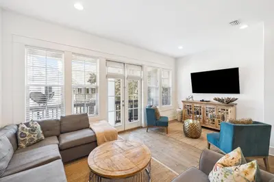 a living room with a couch and a tv at 275 Lifeguard Loop by 30A Escapes in Rosemary Beach