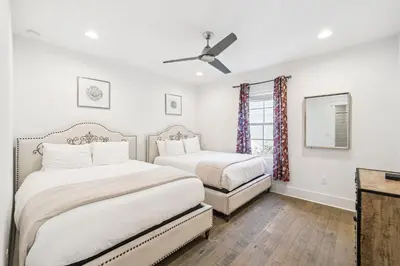 a bedroom with two beds and a ceiling fan at 275 Lifeguard Loop by 30A Escapes in Rosemary Beach
