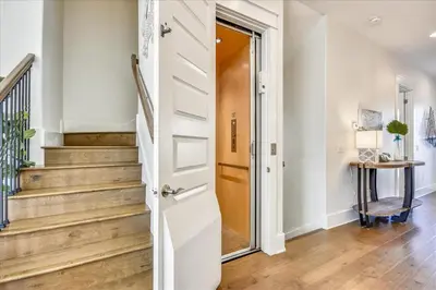a door leading to a hallway with stairs at Sail Away by 30A Escapes in Rosemary Beach