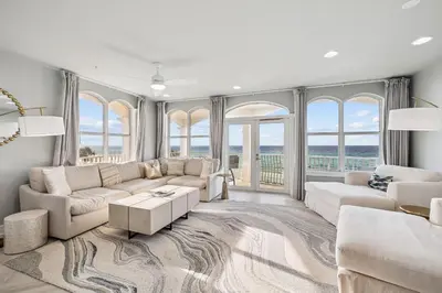 a living room with white furniture and large windows at Beachfront Bliss On 30A by 30A Escapes in Seacrest