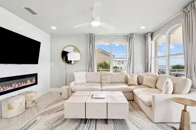 a living room with a couch and a fireplace at Beachfront Bliss On 30A by 30A Escapes in Seacrest