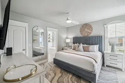a bedroom with a large bed and a mirror at Beachfront Bliss On 30A by 30A Escapes in Seacrest