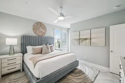 a bedroom with a bed and a ceiling fan at Beachfront Bliss On 30A by 30A Escapes in Seacrest