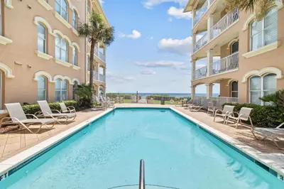 a swimming pool in front of a building at Beachfront Bliss On 30A by 30A Escapes in Seacrest