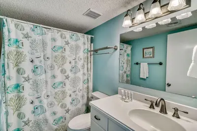 a bathroom with a sink and a shower curtain at 350 Beachfront Trail Unit 4 by 30A Escapes in Seagrove Beach