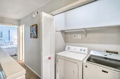 a kitchen with a washer and dryer in a room at 350 Beachfront Trail Unit 4 by 30A Escapes in Seagrove Beach