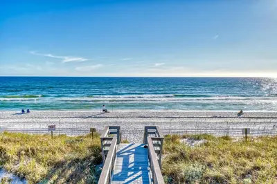 a stairway to the beach with the ocean in the background at 350 Beachfront Trail Unit 4 by 30A Escapes in Seagrove Beach