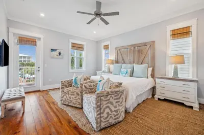 a bedroom with a bed and a couch at Aqua Waters by 30A Escapes in Rosemary Beach