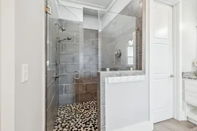 a bathroom with a shower with a glass door at Aqua Waters by 30A Escapes in Rosemary Beach