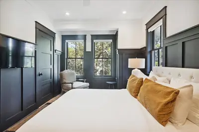 a bedroom with a large white bed and a couch at HollieBird House by 30A Escapes in Watersound Beach