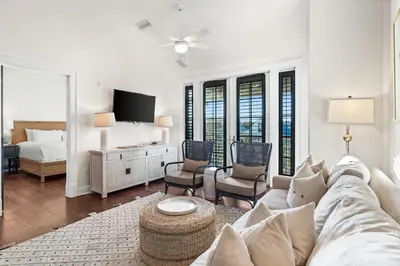 a living room with a couch and a tv at Rosemary Thyme by 30A Escapes in Rosemary Beach