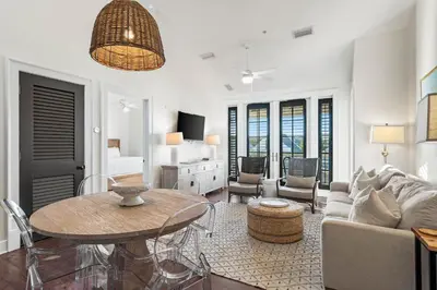 a living room with a table and a couch at Rosemary Thyme by 30A Escapes in Rosemary Beach