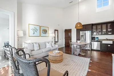 a living room with a couch and a table at Rosemary Thyme by 30A Escapes in Rosemary Beach
