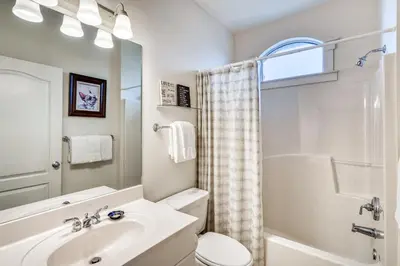 a bathroom with a sink and a toilet and a shower at Castle in the Sand by 30A Escapes in Seacrest