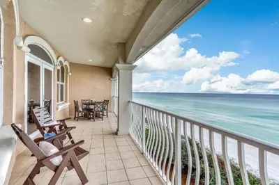 a balcony with chairs and a view of the ocean at Castle in the Sand by 30A Escapes in Seacrest