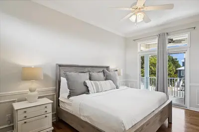a white bedroom with a bed and a window at Shiloh by 30A Escapes in Seacrest