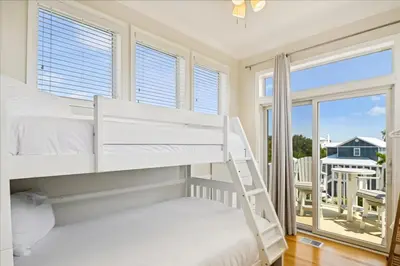 a bedroom with two bunk beds and a balcony at Shiloh by 30A Escapes in Seacrest