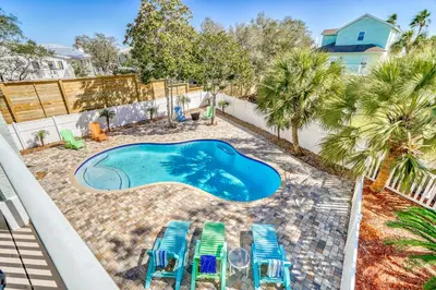 an overhead view of a swimming pool with lounge chairs and a swimming pool at Shiloh by 30A Escapes in Seacrest