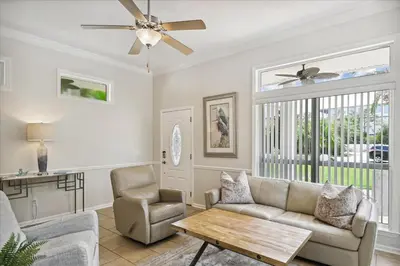 a living room with a couch and a ceiling fan at Shiloh by 30A Escapes in Seacrest