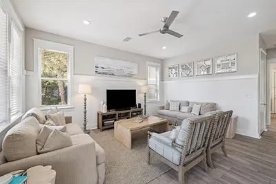 a living room with two couches and a tv at Ocean Pearl by 30A Escapes in Rosemary Beach