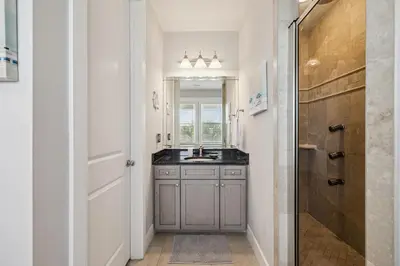 a bathroom with a sink and a mirror at Ocean Pearl by 30A Escapes in Rosemary Beach