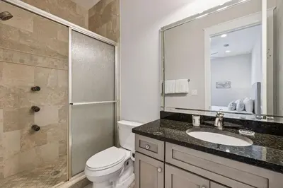 a bathroom with a toilet and a sink and a shower at Ocean Pearl by 30A Escapes in Rosemary Beach