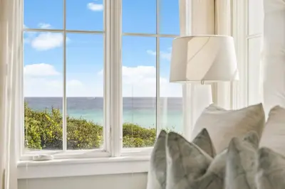 a bedroom with a window looking out at the ocean at Three Amigos Gulf Front by 30A Escapes in Seagrove Beach