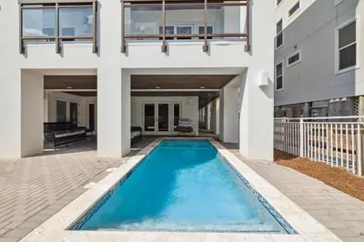 a swimming pool in the backyard of a house at Three Amigos Gulf Front by 30A Escapes in Seagrove Beach