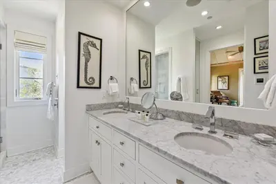 a bathroom with two sinks and a large mirror at Timeless by 30A Escapes in Rosemary Beach