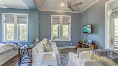a living room with blue walls and a ceiling at Timeless by 30A Escapes in Rosemary Beach