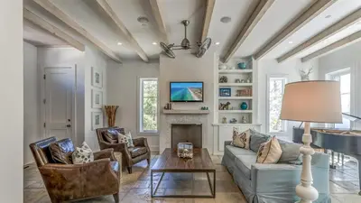 a living room with a couch and a fireplace at Timeless by 30A Escapes in Rosemary Beach