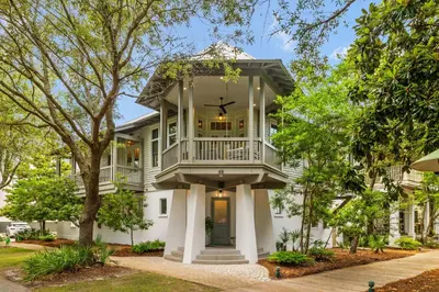 a large white house with a large balcony at Amen Corner by 30A Escapes in Rosemary Beach