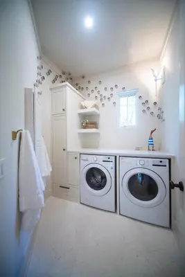 a white laundry room with a washer and dryer at Amen Corner by 30A Escapes in Rosemary Beach