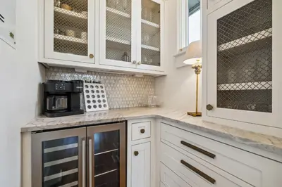a kitchen with white cabinets and a microwave at Amen Corner by 30A Escapes in Rosemary Beach