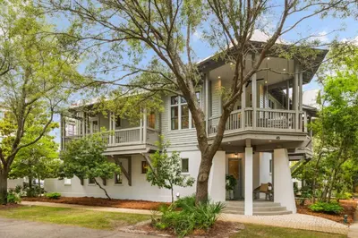 a large white house with balconies and trees at Amen Corner by 30A Escapes in Rosemary Beach