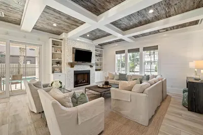 a living room with white furniture and a fireplace at High Noon by 30A Escapes in Rosemary Beach