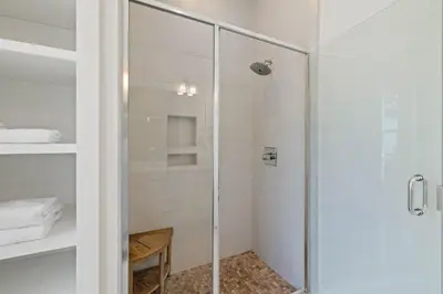 a shower with a glass door in a bathroom at High Noon by 30A Escapes in Rosemary Beach