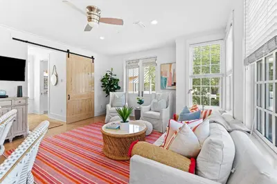 a living room with a couch and a table at Sands Cottage Carriage by 30A Escapes in Rosemary Beach