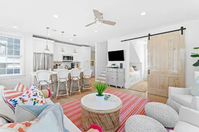 a living room with a couch and a table at Sands Cottage Carriage by 30A Escapes in Rosemary Beach