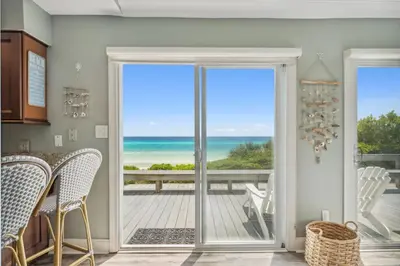 a dining room with a view of the ocean at Dolphin Watch 4 by 30A Escapes in Seacrest