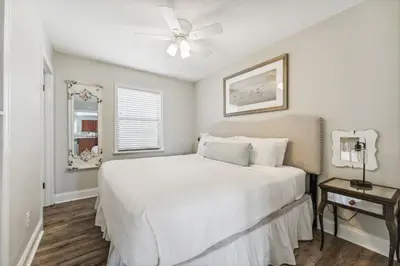 a bedroom with a white bed and a ceiling fan at Dolphin Watch 4 by 30A Escapes in Seacrest