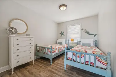 a bedroom with two twin beds and a dresser at Dolphin Watch 4 by 30A Escapes in Seacrest