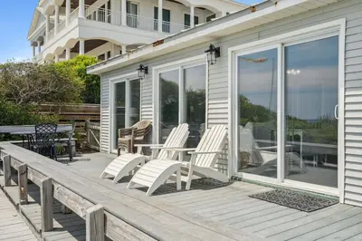 a porch with two chairs and a table on it at Dolphin Watch 4 by 30A Escapes in Seacrest