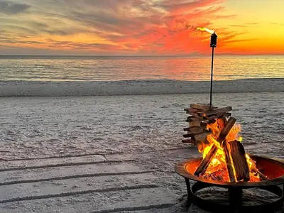 a fire pit on the beach at sunset at Dolphin Watch 4 by 30A Escapes in Seacrest