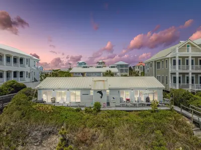 a house on the beach with houses in the background at Dolphin Watch 4 by 30A Escapes in Seacrest