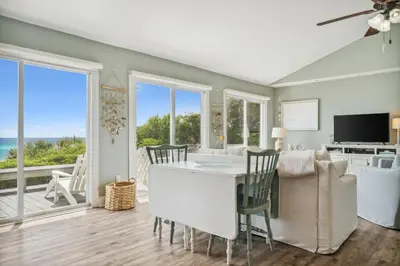 a living room with a table and chairs and a television at Dolphin Watch 4 by 30A Escapes in Seacrest