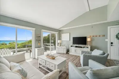 a living room with a couch and a tv at Dolphin Watch 4 by 30A Escapes in Seacrest