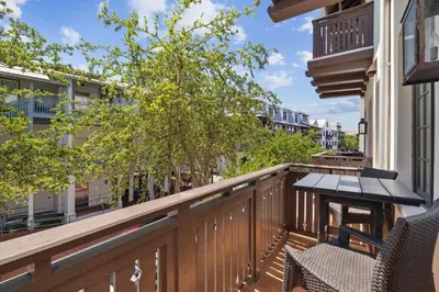 a balcony with two chairs and a table at Ocean`s Six by 30A Escapes in Rosemary Beach