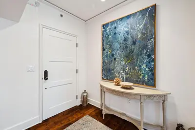 a room with a table and a painting on the wall at Ocean`s Six by 30A Escapes in Rosemary Beach
